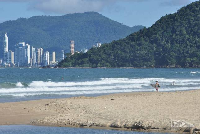Um surfista solitário observa o mar da praia dps Amores. No fundo, os prédios de Balneário Camboriú, litoral de Santa Catarina